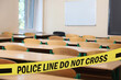 © New Africa - Yellow crime scene tape in empty school classroom