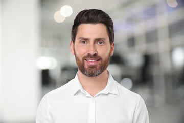 Portrait of handsome confident man in office