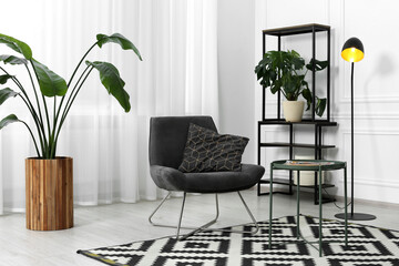 Canvas Print - Stylish grey armchair and small coffee table in living room. Interior design