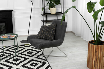 Sticker - Stylish grey armchair and small coffee table in living room. Interior design