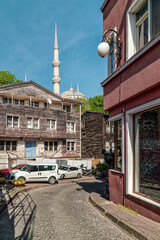 Historic wooden houses, hostels and hotels at the Sultan Ahmet area with the mosque minaret in the background, Istanbul, Turkiye