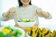 © DG PhotoStock - Happy Asian beautiful woman enjoy eating a vegetable salad with boiled eggs. Healthy eating lifestyles concept.