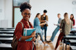 © Drazen - Happy black female student at university looking at camera.