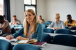 © Drazen - Happy mid adult woman attending educational course in classroom and looking at camera.