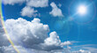 Leinwandbild Motiv 夏の晴天、青空に流れる積乱雲ふわふわの入道雲とギラギラ輝く太陽とレンズフレアの背景壁紙　夏・夏休み・行楽・バカンス・アウトドア・キャンプ・天気・台風一過