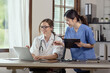 © SOMKID - Two female doctor working at desk in clinic office, Teamwork in medicine and healthcare concept.