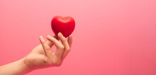 Adult Hands Giving A Red Heart, Health Care, Organ Donation, Family Life Insurance, World Heart Day, World Health Day, Praying Concept