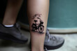 Bicycle silhouette on the foot, Minimal tattoo, 