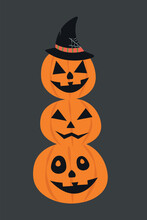 Three Different Halloween Pumpkins With Carved Grins Stand On Top Of Each Other In A Pyramid
