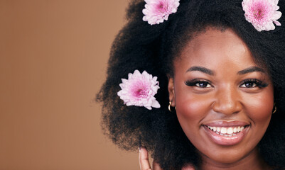 Wall Mural - Flowers, face and black woman in afro hair care, smile and beauty in studio isolated on a brown background mockup space. Portrait, floral hairstyle cosmetic and natural African model in organic salon