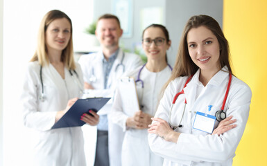 Medical doctors in white coats stand together. Medical staff and united team concept