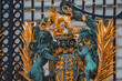 Closeup shot of lions on metal gate. Entrance of Buckingham Palace. Black and golden fence of famous kingdom in London.