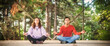 © guruXOX - Young couple in everyday casual clothing doing yoga relax exercise in nature park outdoor