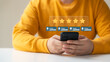 © Thapana_Studio - customer satisfaction survey concept business people use smartphone Touch the happy smiley icon. Satisfied. 5 stars. Service experience rating. online application Satisfaction Review best quality.