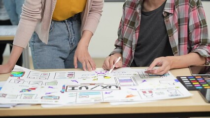 Young Asian business creative developer team work design. Creative UI Ux designer meeting planning designing wireframe layout application development for smartphone screen mobile phone technology