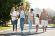 © aLListar/peopleimages.com - Outdoor, big family and walking in neighbourhood street together for fun, bonding or activity with kids, parents and grandparents. Happy, time and relax in urban summer with children on vacation