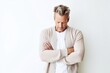 © Leon Waltz - Lifestyle portrait photography of a man in his 40s appearing tired and down due to hypothyroidism wearing a chic cardigan against a white background