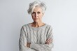 © Leon Waltz - Group portrait photography of a woman in her 50s looking anxious and fidgety due to generalized anxiety disorder wearing a cozy sweater against a white background