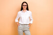 © deagreez - Photo of brunette young business lady put hands pockets clothes pants white shirt company director isolated on beige color background
