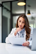© bnenin - A thoughtful female doctor analyzes results on paper at the ambulance table.