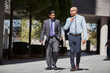 © Connect Images - Businessmen walking along sidewalk together