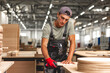 © fotofabrika - Young carpenter making wood furniture while working in joinery