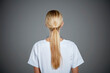 © Connect Images - Rear view of young woman with ponytail.