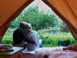 © Connect Images - Mature married couple sitting in tent together.