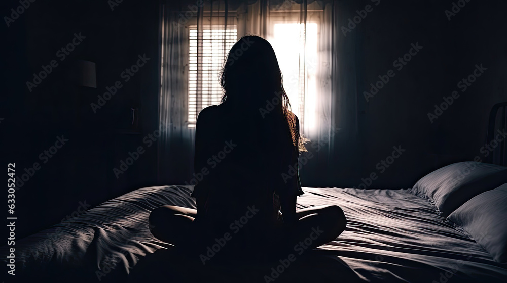 Silhouette of Sad unhappy woman sitting on the bed with hands on head ...