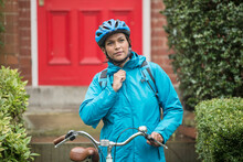 Woman In Blue Jacket Commuting By Bicycle