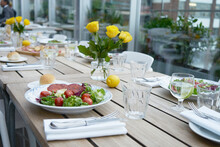 Salad On Set Table With Yellow Roses
