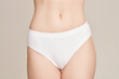 © Connect Images - Groin of young woman wearing white underwear