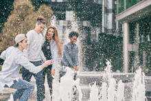Teenagers Playing With Water Fountain