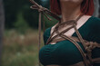 © Arlington Vance - breast of beautiful redhead woman in green body tied with shibari rope Kinbaku japanese bandage