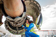 © Connect Images - Men working on airplane engine