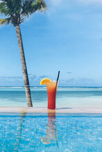 Cocktail Between Swimming Pool And Tropical Beach