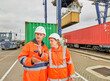 © Connect Images - Dock workers talking by railway tracks at Port of Felixstowe, England