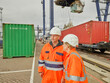© Connect Images - Dock manager and work talking while freight train is loaded