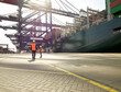 © Connect Images - Dock workers beside cargo ship at Port of Felixstowe, England