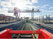 © Connect Images - Railway buffer stop in dockyard with train in distance, Felixstowe, England.