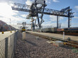 © Connect Images - Railway tracks with cargo cranes in dockyard, Felixstowe, England.