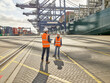 © Connect Images - Dock workers standing by cargo ship having conversation, Felixstowe, England.