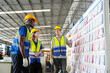 © FotoArtist - Warehouse Industrial supply chain and Logistics Companies inside. Warehouse workers checking the inventory. Products on inventory shelves storage. Worker Doing Inventory in Warehouse.