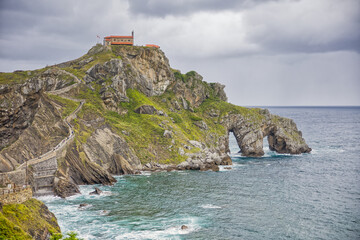 Wall Mural - view of gaztelugatxe island with cloudy dramatic sky and stormy weather