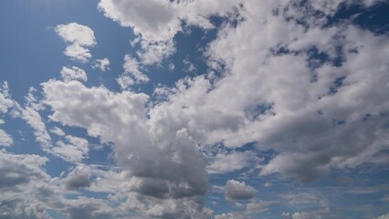 Wall Mural - blue sky white clouds. puffy fluffy white clouds. cumulus cloud cloudscape timelapse. summer blue sk