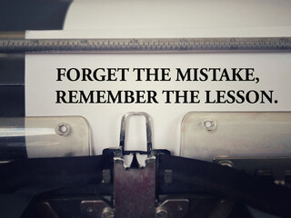 Motivational and inspirational wording. Forget The Mistake, Remember The Lesson. With blurred styled background.