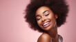 © ckybe - Gorgeous African American woman showcases flawless, radiant skin against a beige backdrop. A captivating smile graces Afro beauty with luscious, curly black hair.