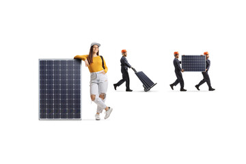 Wall Mural - Female student leaning on a panel and factory workers carrying photovoltaic cells