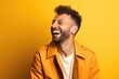 © 4kclips - Portrait of a handsome mature man laughing on a plain studio background.