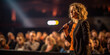 © Bnetto - Speaker Woman Performing on Stage and Speaking to Large Audience, Event Professional.